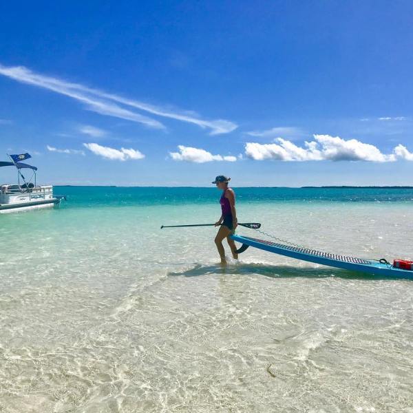 a man riding on the back of a boat in a body of water