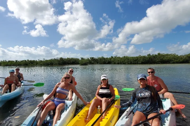 a group of people kayaking in key west